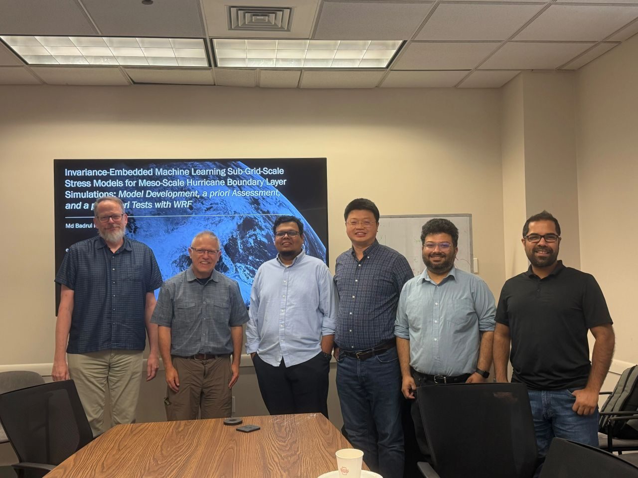 Group photo with committee members and colleagues after the defense