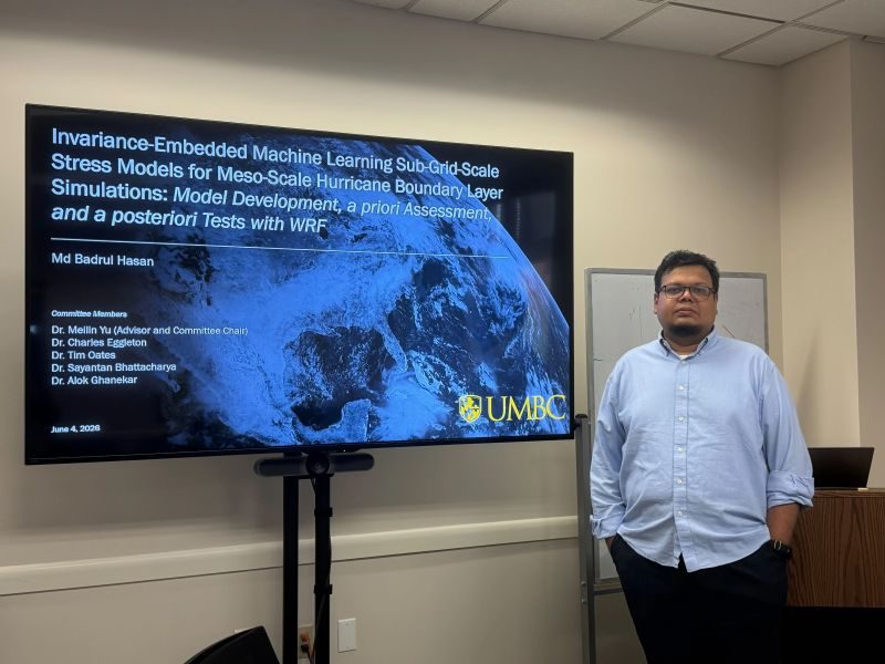 Standing beside the dissertation title slide